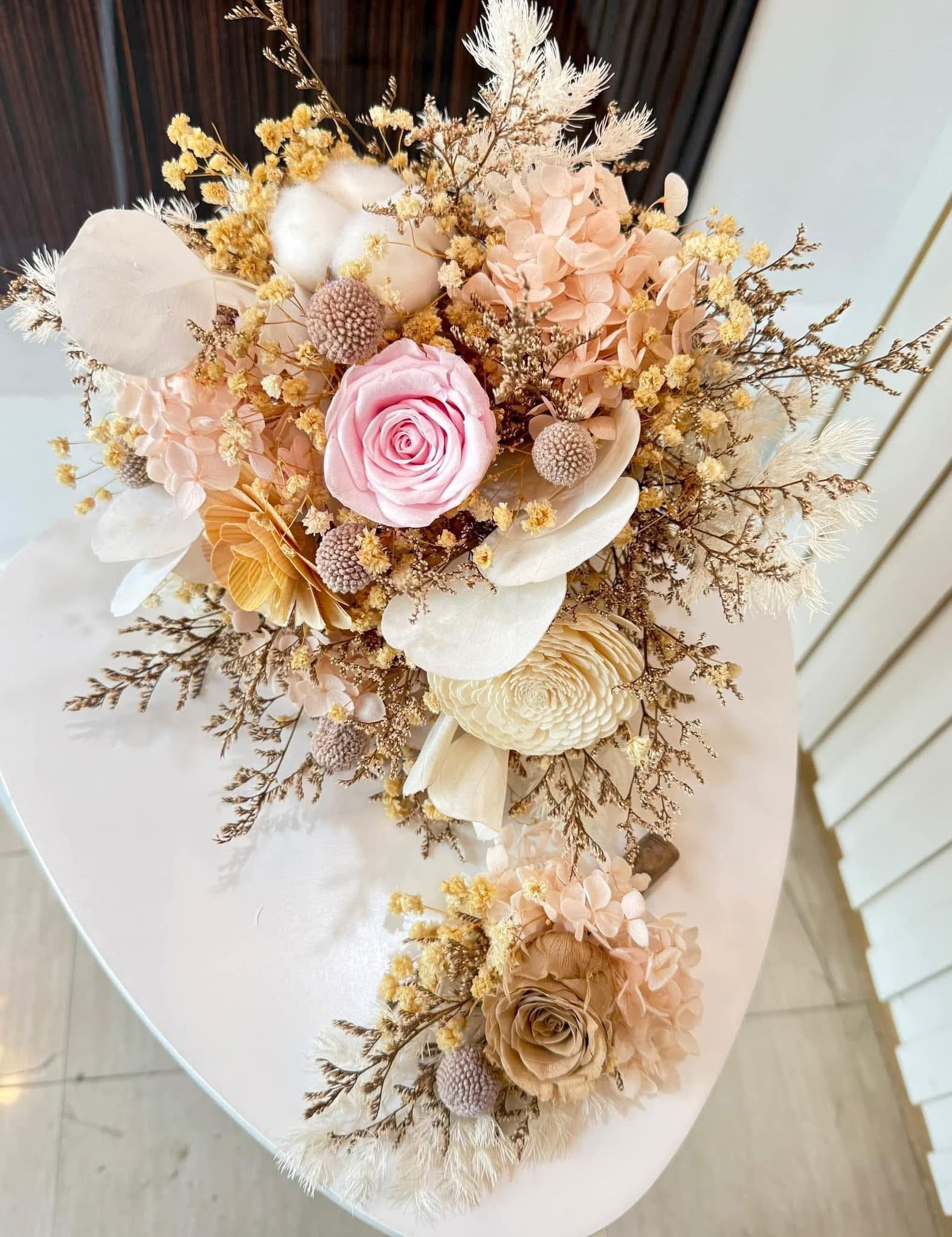 Preserved pink rose, hydrangea, and cotton bridal bouquet with matching boutonniere